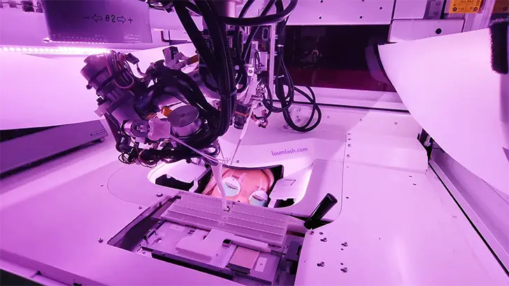 Luum Lash robot performing AI-powered lash extensions